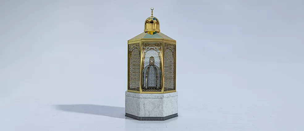 Maqam Ibrahim stone inside a clear glass casing with gold details, showing faint footprints of Prophet Ibrahim