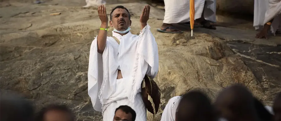 Muslim pilgrims praying on Mount Arafat
